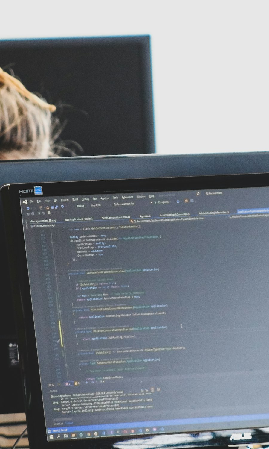 Developers coding at monitors in a modern workspace